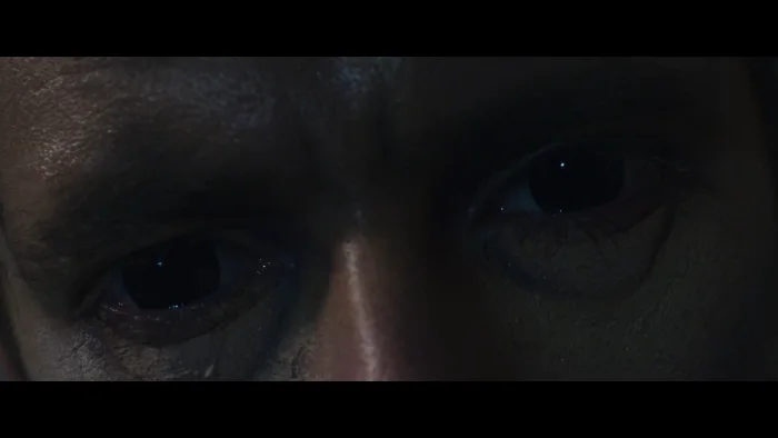 Extreme close-up of a man's eyes turned fully black